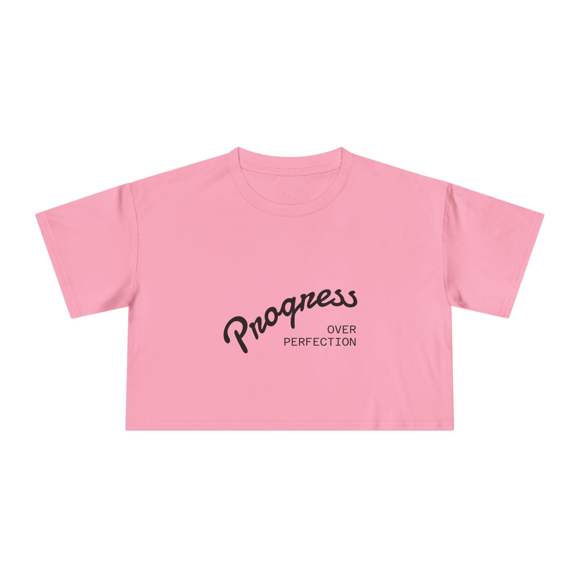 Pink crop top with 'Progress Over Perfection' text on a white background