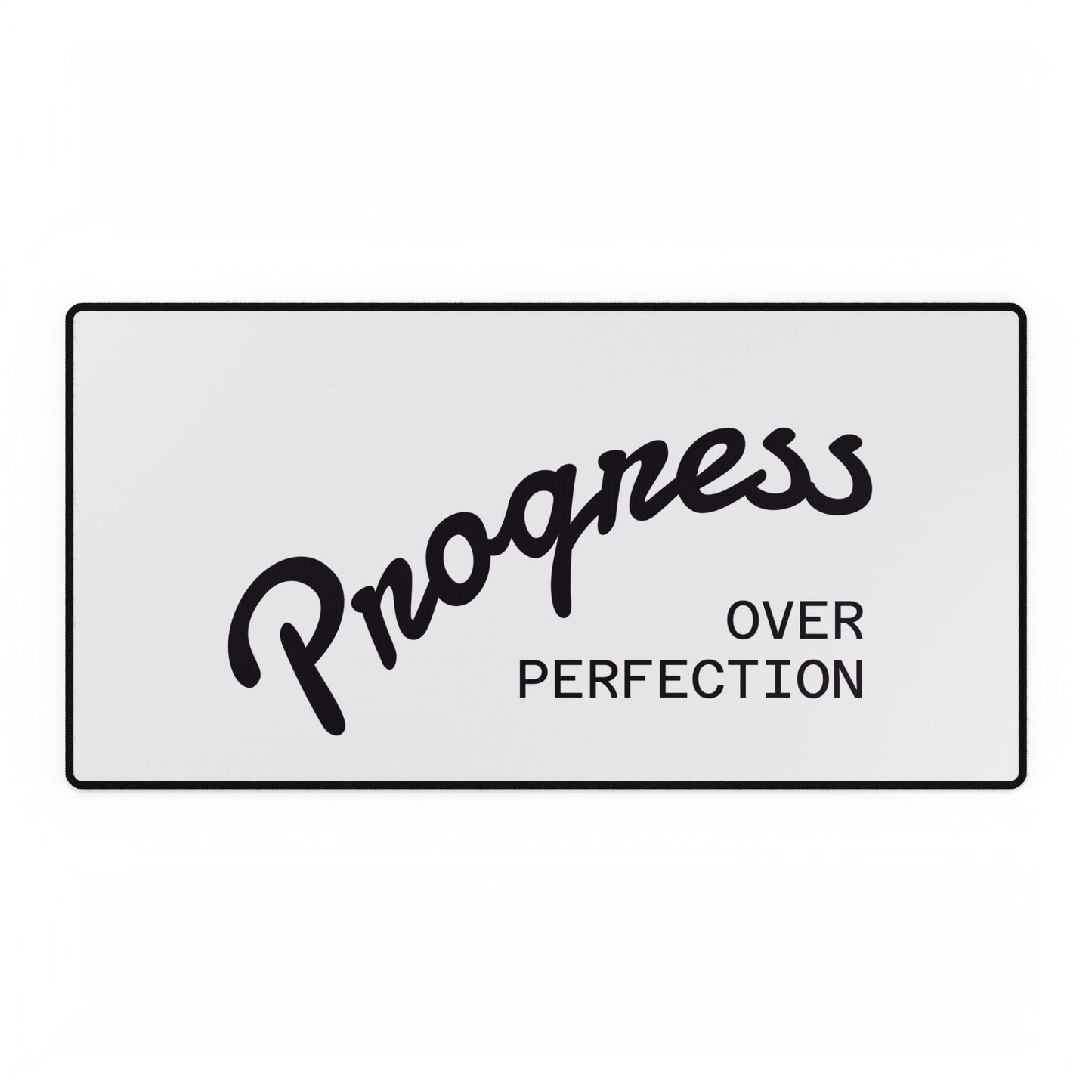 Progress Over Perfection white desk mat close-up showing black script typography
