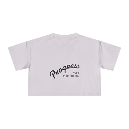 White crop top with 'Progress Over Perfection' text on a white background