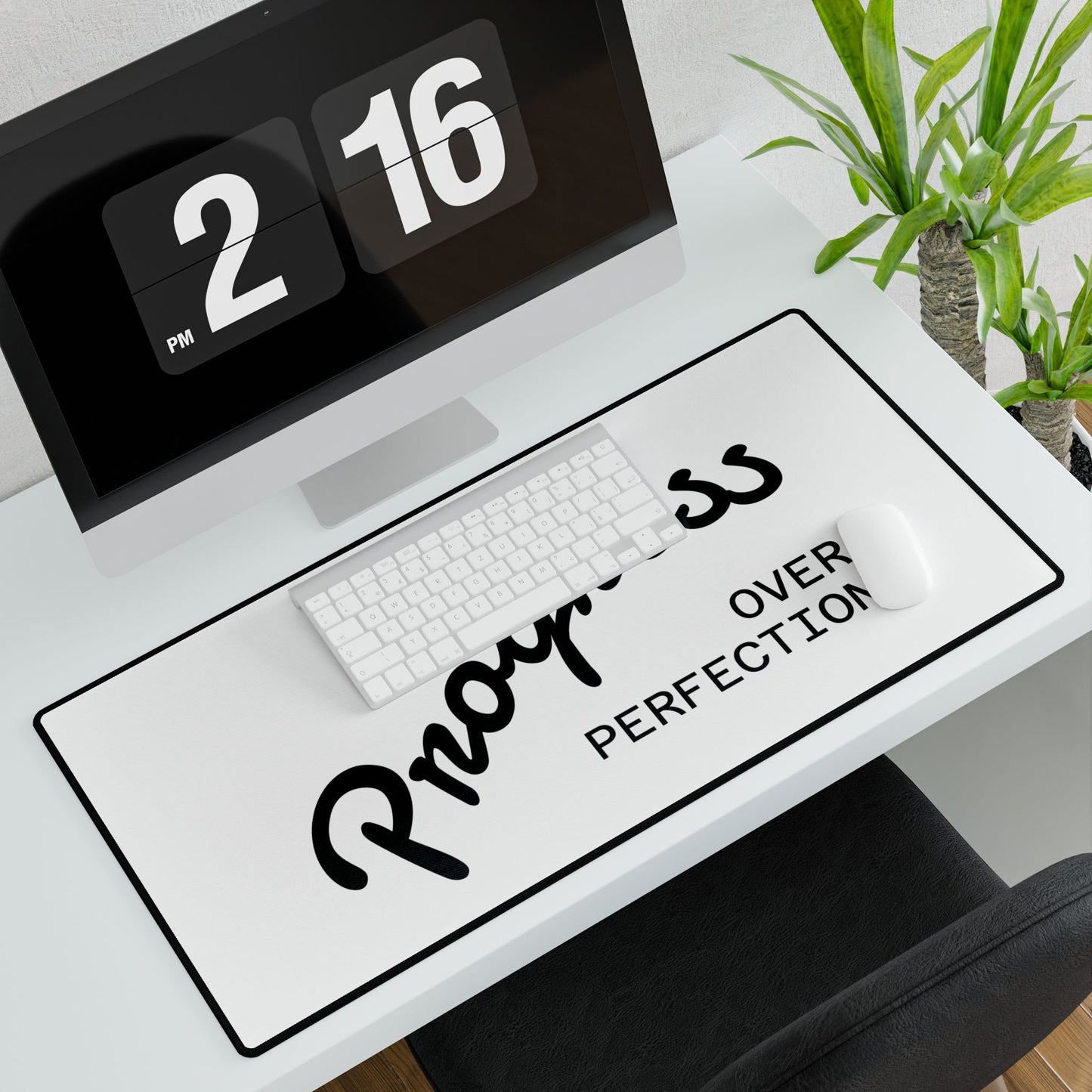 rogress Over Perfection desk mat in modern workspace with flip clock and plants
