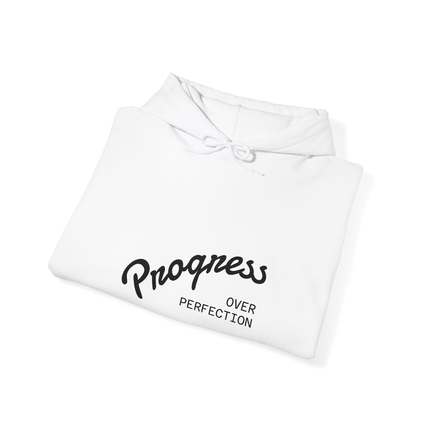 Folded white hoodie with 'Progress Over Perfection' text on a white background