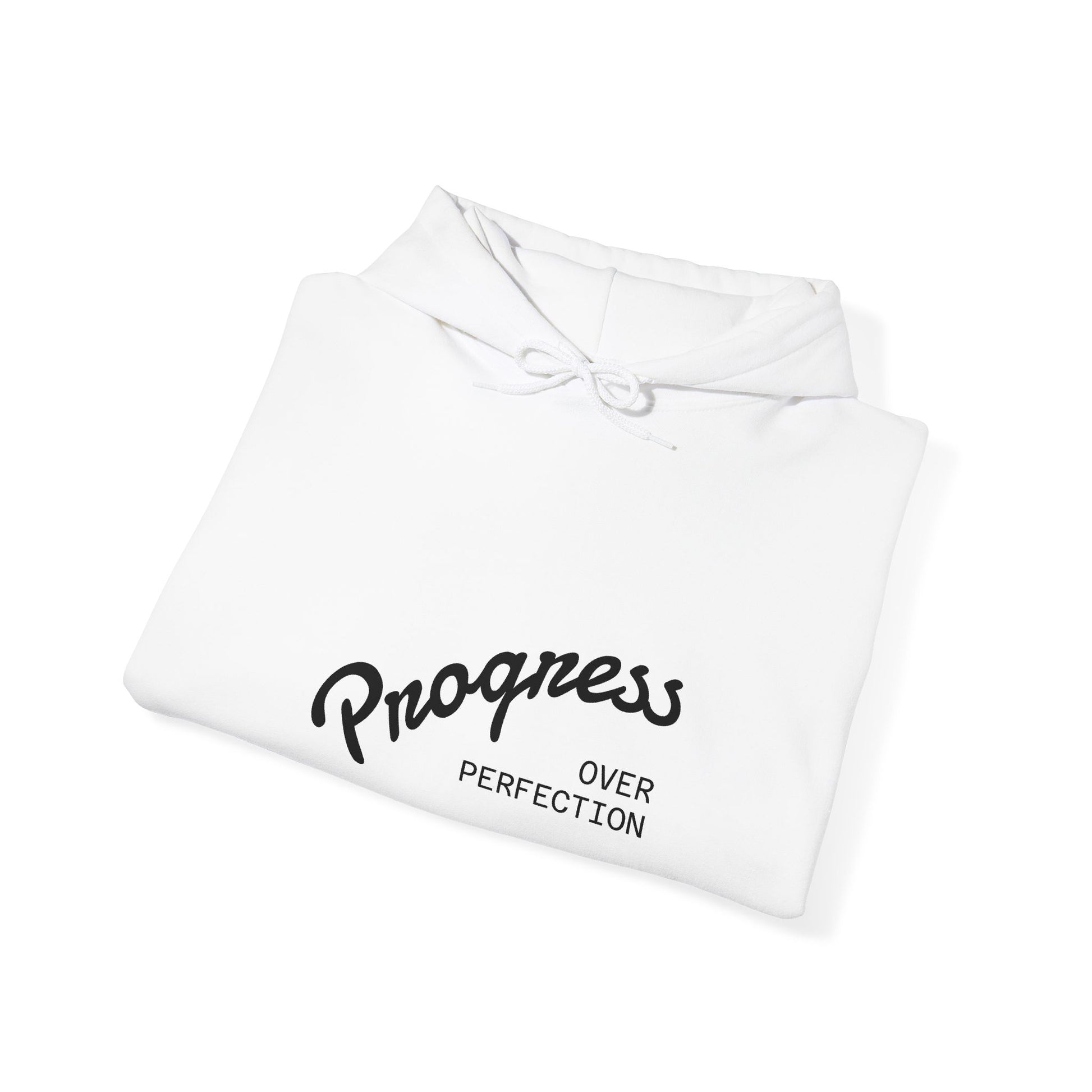 Folded white hoodie with 'Progress Over Perfection' text on a white background