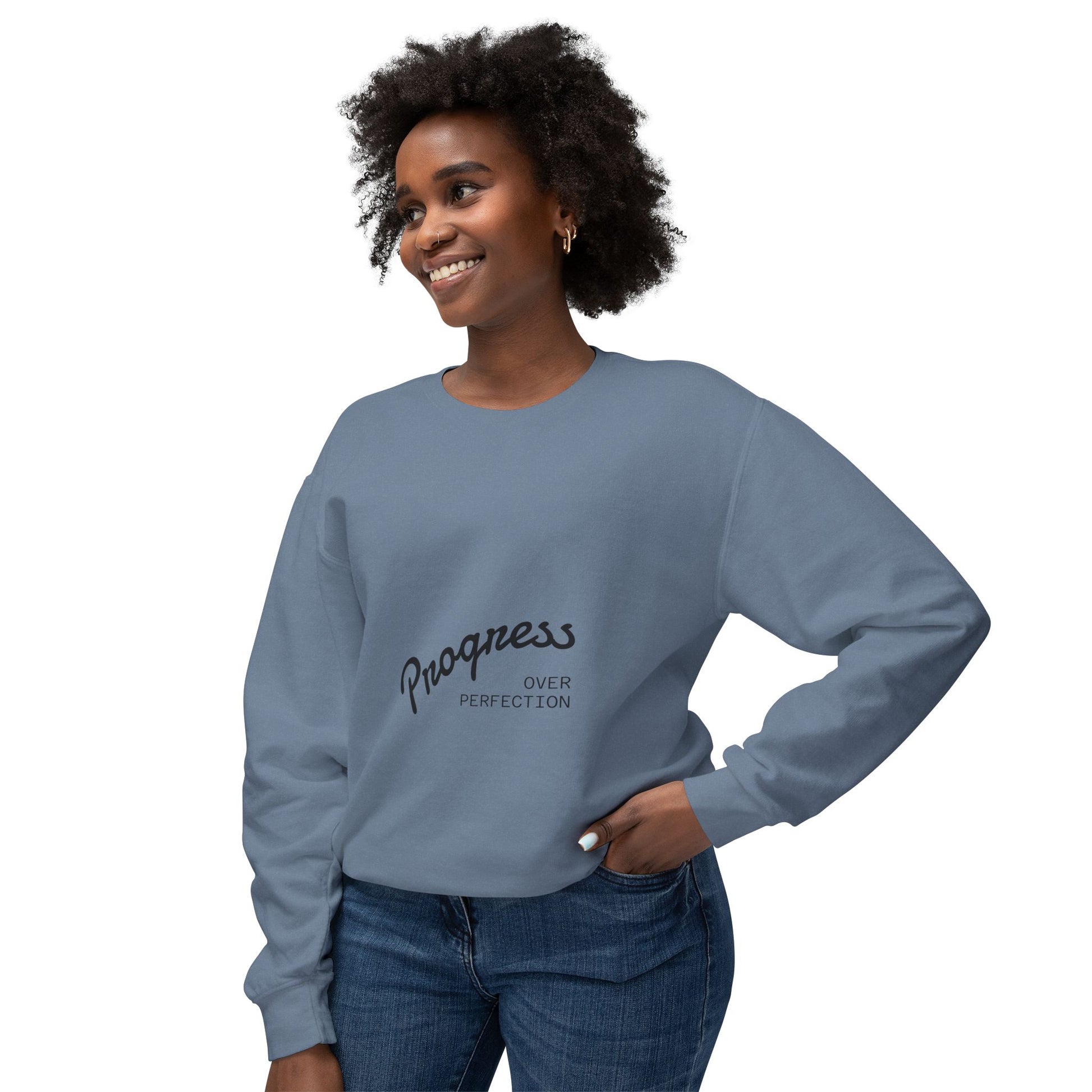 Woman wearing progress over perfection blue grey crewneck sweatshirt, comfortable motivational apparel for casual wear
