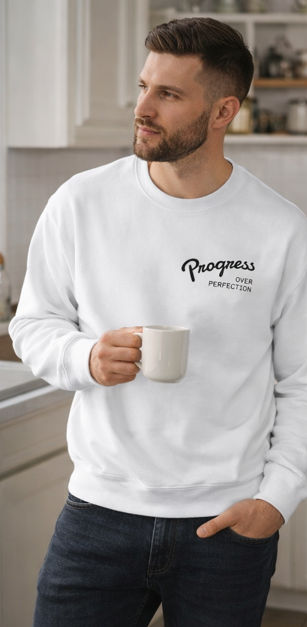 Man wearing Progress Over Perfection white crewneck sweatshirt with coffee motivational lifestyle apparel