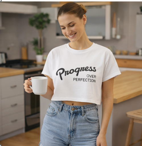 Woman in Progress Over Perfection white crop top in kitchen casual lifestyle motivational clothing