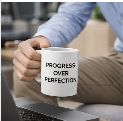 Progress over perfection ceramic mug close-up, motivational coffee cup with bold black text, perfect gift for goal-driven individuals
