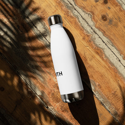 Growth motivational insulated water bottle on wooden surface, white stainless steel bottle for daily hydration and wellness
